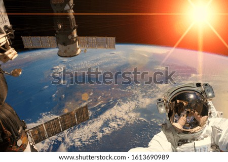 Astronaut and sunrise. The elements of this image furnished by NASA.
