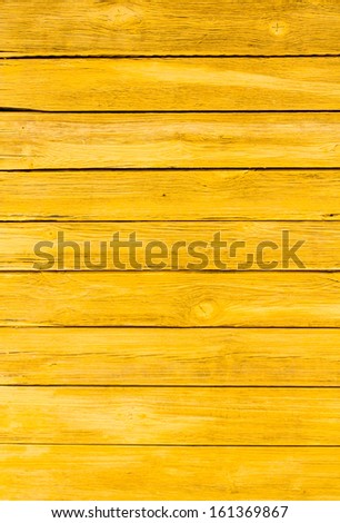 Orange flaky paint on a wooden fence.