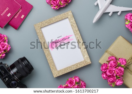 Mockup golden picture frame for travel with valentines day & love season background concept. Top view of mock up photo frame with rose flowers, craft roses, passport, camera, airplane model