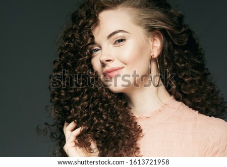 Curly hair female portrait beauty concept woman face close up healthy skin natural make up