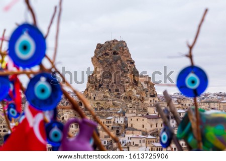 Blue evil eye / nazar boncuğu, Turkish symbols hanging on a tree; Cappadocia, Ortahisar Castle