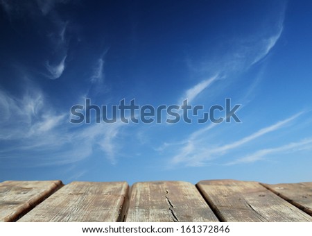 blue sky with old wooden table background