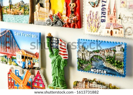 Many magnets on fridge from different countries, travel concept
