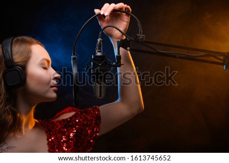 Girl singing into a microphone. Love for music. Screensaver for learning music or vocals.