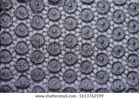 Light grey lacy fabric directly from above