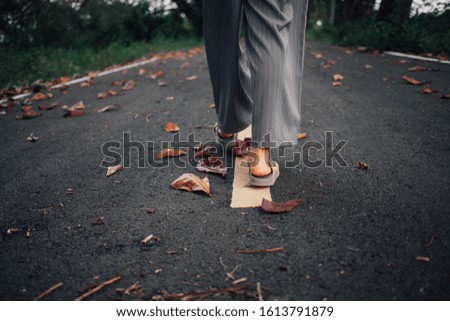 A woman who walks alone on an empty road Who are feeling lonely and alone