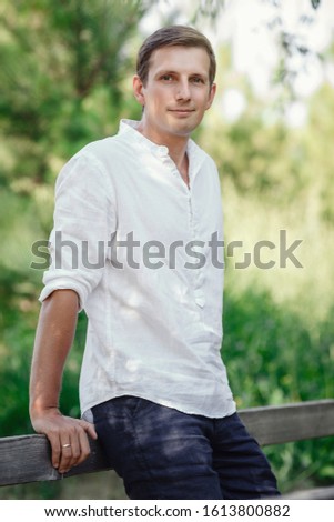 young courageous man in the summer garden. idea and relaxation concept