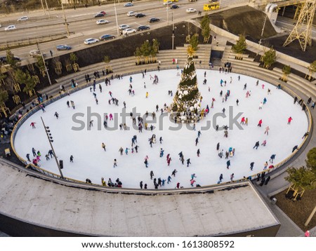 Aerial view. People skate near the New Year tree.