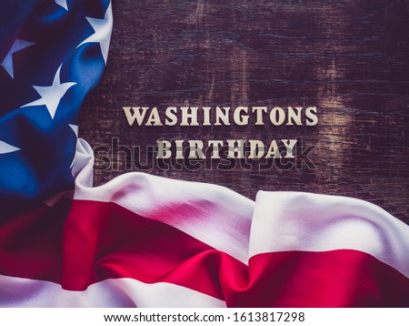 Washington's Birthday, Presidents' Day. Beautiful greeting card. Brown, isolated background, close-up, top view, wooden surface. Congratulations for relatives, friends and colleagues