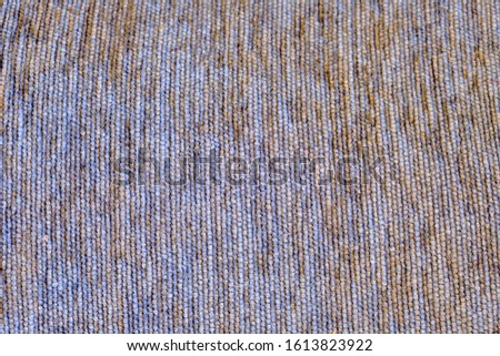 Texture of coarse fabric with a seam in a line. Grey cloth background with smooth lines.