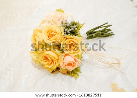 Bouquet of yellow marbella roses on wedding dress
