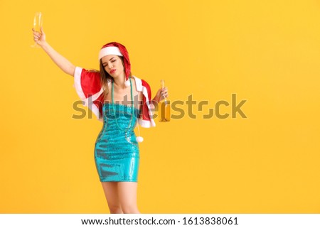 Drunk woman in Santa Claus costume and with champagne on color background