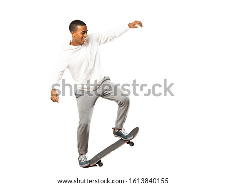 Full-length shot of Afro American skater man over isolated white background