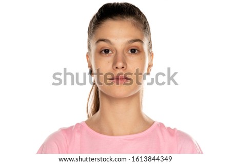 Portrait of young beautiful woman without makeup, and with moles on white background Royalty-Free Stock Photo #1613844349