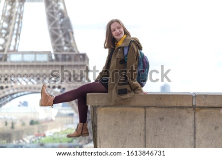 happy girl on the background of the Eiffel Tower in Paris. France
