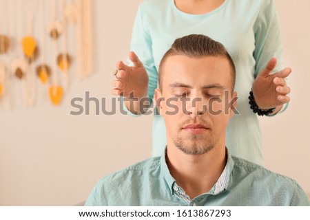 Reiki master working with patient Royalty-Free Stock Photo #1613867293