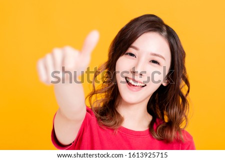 Closeup of Smiling Woman Making thumbs up  Gesture