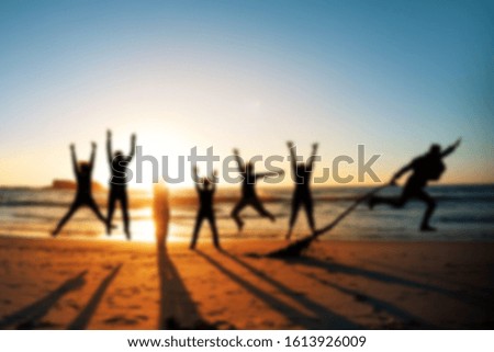 
sunset by the ocean on which happy people. Blurred picture on which people are resting on the ocean at sunset.
Happy people having fun on sunset background by the ocean