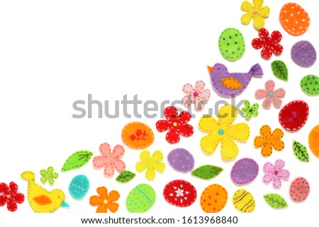Easter border design on white. Festive background of colored eggs, flowers, birds, leaves, decorated with embroidery. Decorative felt elements with stitches on the edges for banner, cover, copy space.