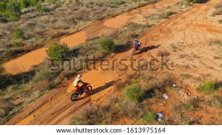 Aerial drone of moto cross dirt bike in compete in dirt track