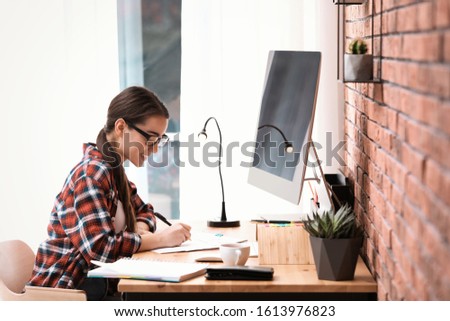 Professional journalist working with computer in office