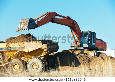 loader excavator and tipper dumper. earthmoving work Royalty-Free Stock Photo #1613995345