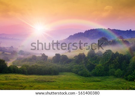 cold morning fog with red hot sunrise and rainbow in the mountains Royalty-Free Stock Photo #161400380
