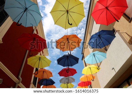 Umbrella street decoration. The blue sky of colorful umbrellas in the city. Umbrella Sky Project.