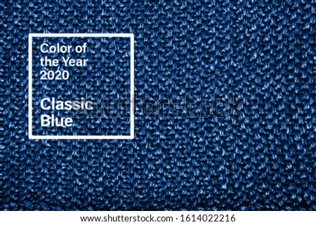 Classic blue color trend 2020 hand craft knitted wool sweater fragment.