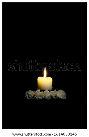 Sympathy card with White roses with a burning candle on the dark background. funeral flower Condolences card. Mood, Prayers and Deepest Sympathy concept. Empty place for a text Royalty-Free Stock Photo #1614030145