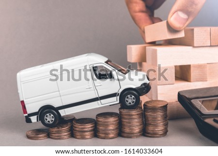A freight bus rises up the steps of coins. Delivery business development concept