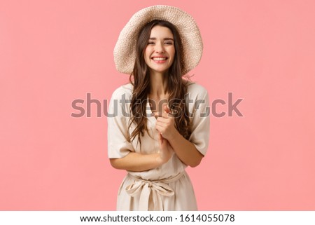 Elegant and feminine beautiful young woman clasp hands and smiling as enjoying nice casual conversation with group friends, shopping, smiling and laughing enthusiastic, pink background