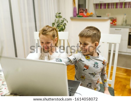 Children watch a cartoon on a laptop