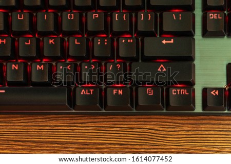 part of the black keyboard with a red backlight near the enter key