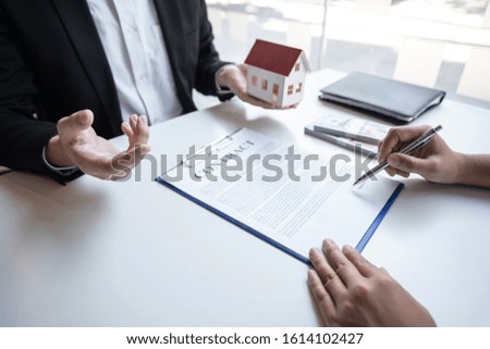 Real estate agent are presenting home loan and sending keys to customer after signing contract to buy house with approved property application form, Insurance Home concept.