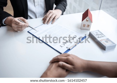 Real estate agent are presenting home loan and sending keys to customer after signing contract to buy house with approved property application form, Insurance Home concept.