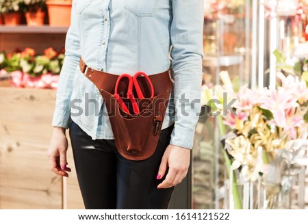 florist girl in holster organizer for floristic tools Royalty-Free Stock Photo #1614121522