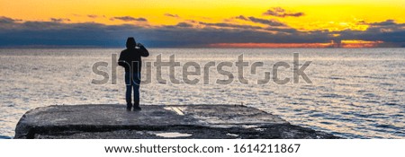 Man at sunset by the sea