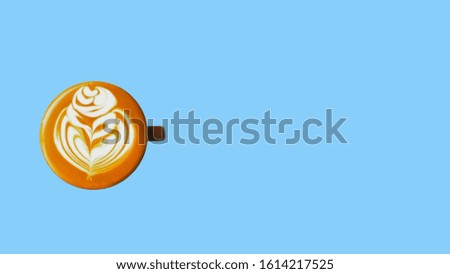 Top view of coffee latte in dark brown cup isolated on the pastel sky blue background. Copy space and pastel concept.