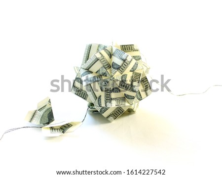 Handmade money origami ball. Kusudama polyhedron on a white background