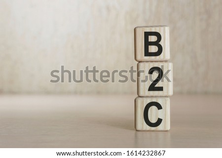 B2C , business to business marketing, on wooden cubes over beige background, banner
