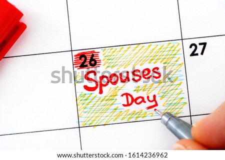 Woman fingers with pen writing reminder Spouses Day in calendar. January 26.  Royalty-Free Stock Photo #1614236962