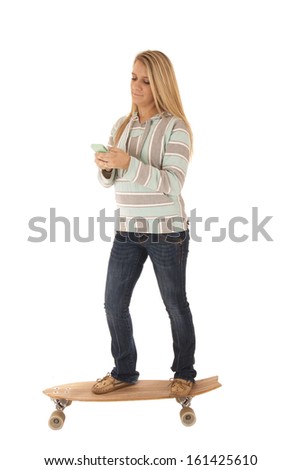 woman texting riding on her skate board