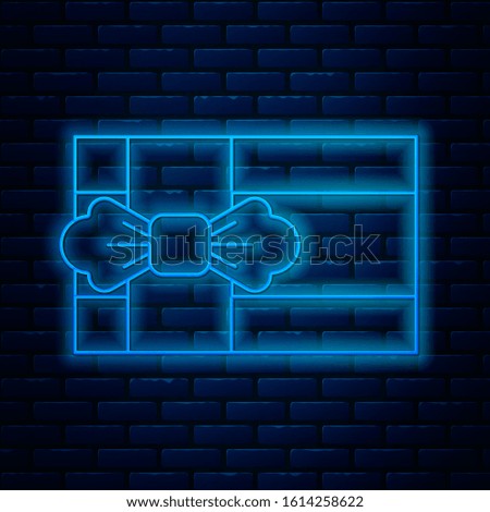 Glowing neon line Gift box icon isolated on brick wall background.  Vector Illustration