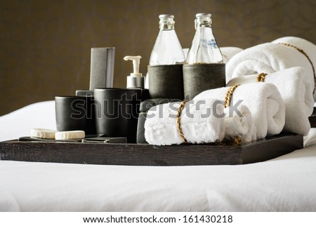 Set of bath accessories on bed
