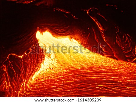 Detailed view of an active lava flow, hot magma emerges from a crack in the earth, the glowing lava appears in strong yellows and reds - Hawaii, Big Island, Kilauea volcano, Puna district, Kalapana Royalty-Free Stock Photo #1614305209
