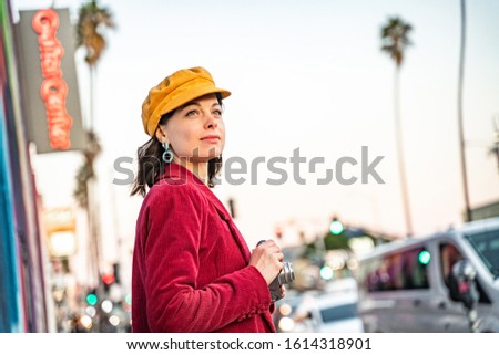 Smiling girl with a retro camera in Los Angeles