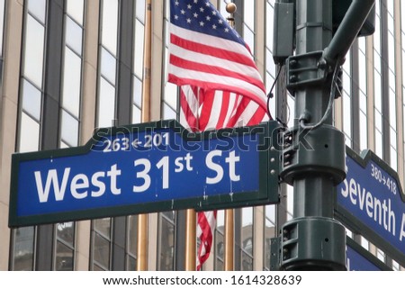New York City West 31st Street Sign with American flag in background