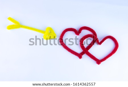 Red heart and Arrow. Space for text. Infinite love or special occasion concept. The view from the top of the red velvet hearts and arrows. Copy space. Portrays a love passion for a romantic couple.