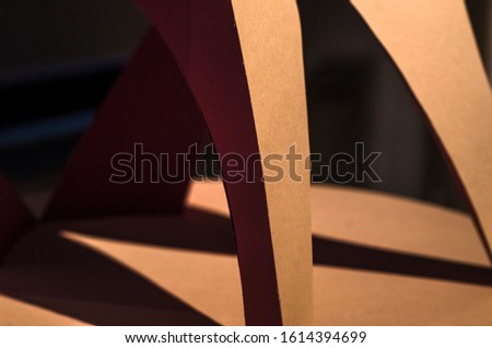 Red paper abstract object with shadows. Origami closeup. Graphic neutral background.
